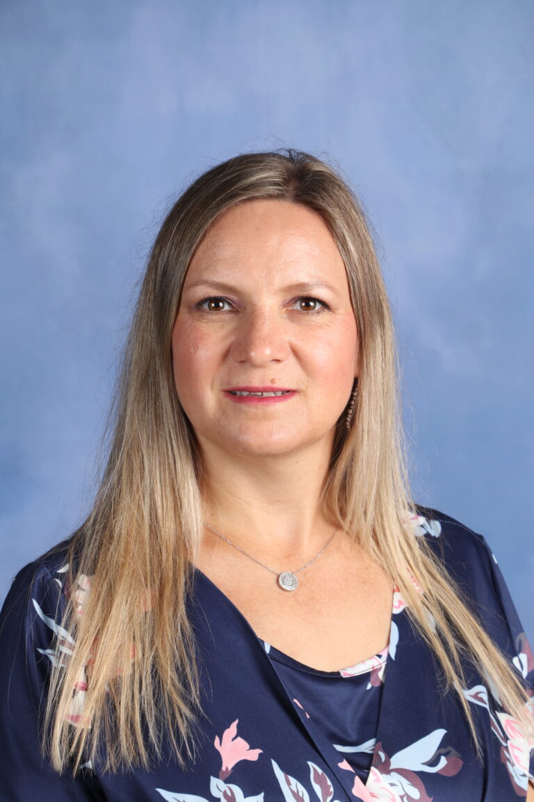 Portrait of Natalia Raicu wearing a floral top and necklace.