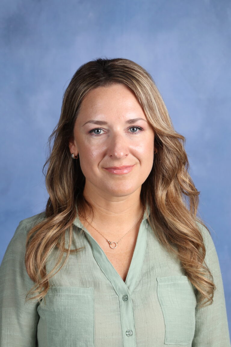 Tetyana Horoian portrait with wavy blonde hair and a sage green shirt.