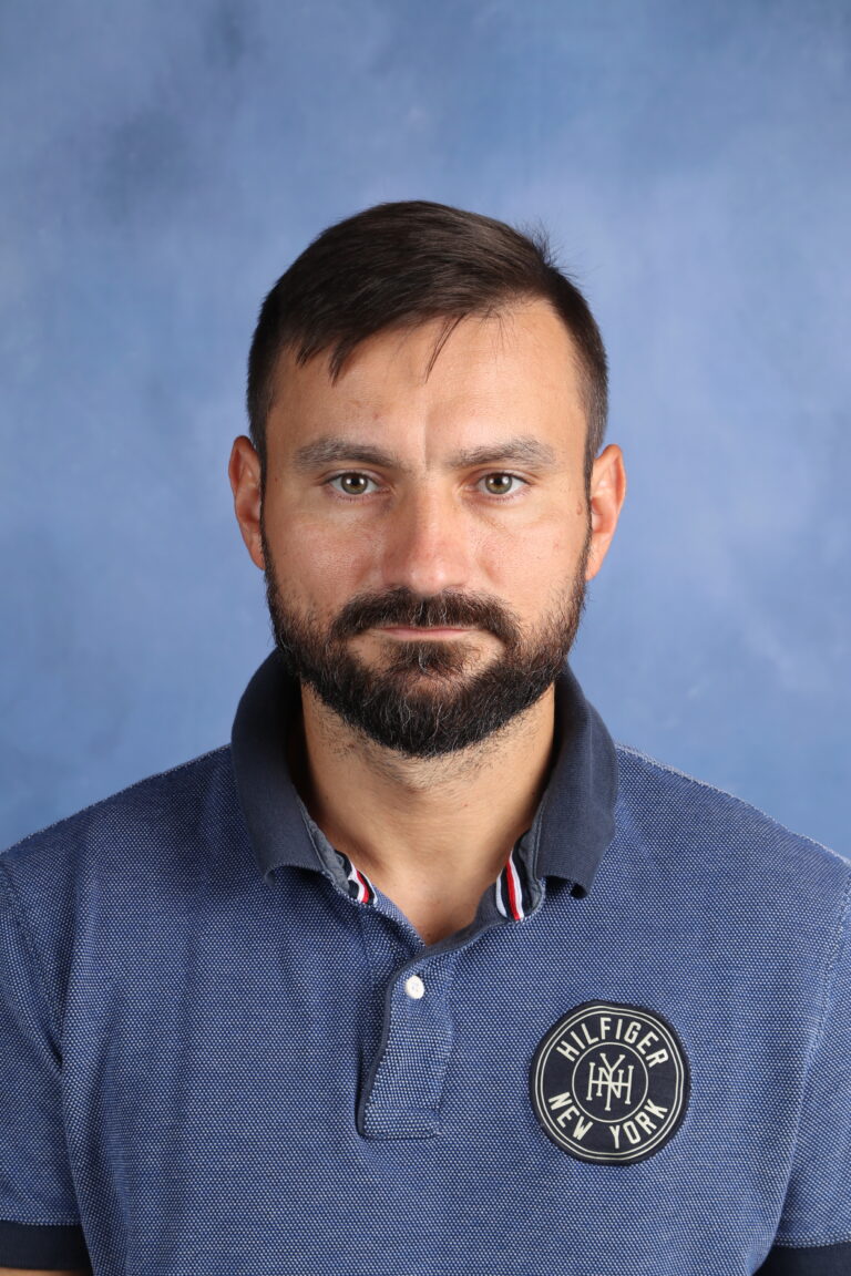 Portrait of Tetyana Horoian, wearing a blue Tommy Hilfiger polo shirt.