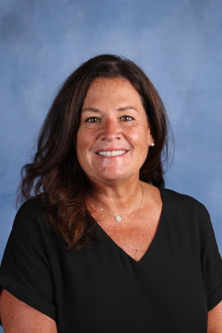 Debbie Porter smiles in a professional headshot, wearing a black top and necklace.