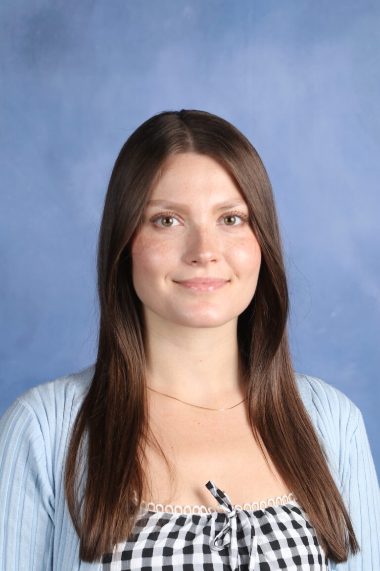 Eleanora Hutsol headshot. Portrait of a smiling woman with long brown hair.